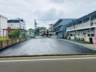 道路に面した外観写真です。敷地が広く周囲には住宅や建物が建ち並んでいます。前面道路との高低差が少なく車の出入りもスムーズにできます。整った形状の敷地です。近隣には生活施設も揃っています。