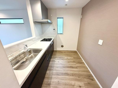 明るく開放的なキッチン空間です。作業スペースが広く効率的に調理ができます。収納も豊富で片付けやすい設計です。シンプルなデザインが魅力的な印象を与えます。床や壁の色合いが調和されており清潔感があります。