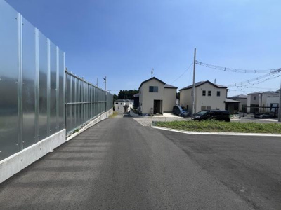 前面道路が広くゆとりのある空間が広がっています。住宅街の中に位置し周辺には整備された道路が続いています。現地は車の出入りがしやすくアクセスも良好です。舗装された道路が安心感を与えます。