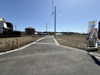 開放感のある現地土地写真です。周囲は広々とした畑や自然が広がっています。陽当たりも期待できる立地です。近隣には住宅やビニールハウスが点在しています。建築の計画がしやすい整形地となっています。