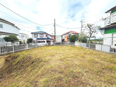 整備された敷地が広がり多彩な活用に対応できる現地土地写真です。道路に面しておりアクセスしやすい立地が魅力的です。周囲は住宅が立ち並ぶ落ち着いた雰囲気です。開放感あるスペースが特徴となっています。