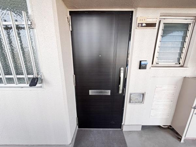 玄関まわりがしっかりとした造りになっています。ドアはしっかりとした素材感が感じられます。外からのアクセスも便利な配置です。周囲には窓もしっかり設置されています。郵便受けもドアに備え付きです。